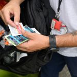 A person holds safer use supplies for distribution.